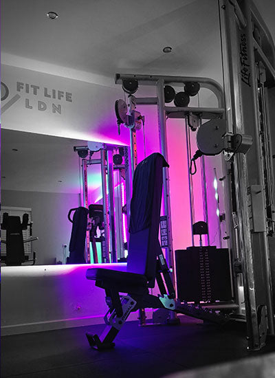 Life Fitness Dual Pulley Machine .Gym interior with colourful LED lights and equipment. Personal Training in West London Southall UB1 at VIP studio 4 mins away from Southall Station with Free Parking