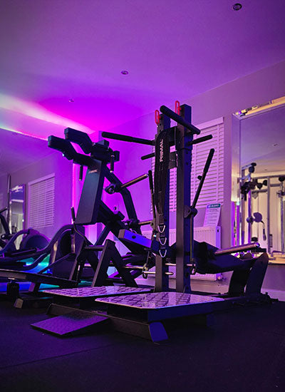 Primal Belted Squat at Fit Life LDN Personal Traininer Training for VIP locals to West London Gym interior with colourful LED lights and equipment. Personal Training in West London Southall UB1 at VIP studio 4 mins away from Southall Station with Free Parking