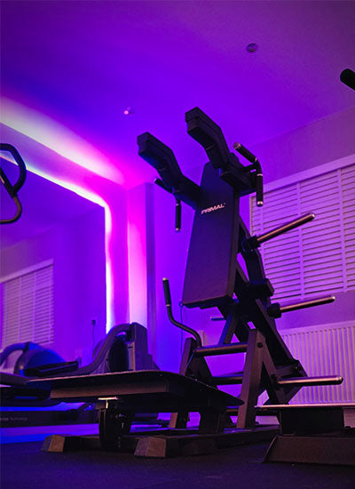 Primal Hack Squat at Fit Life London Gym interior with colourful LED lights and equipment. Personal Training in West London Southall UB1 at VIP studio 4 mins away from Southall Station with Free Parking